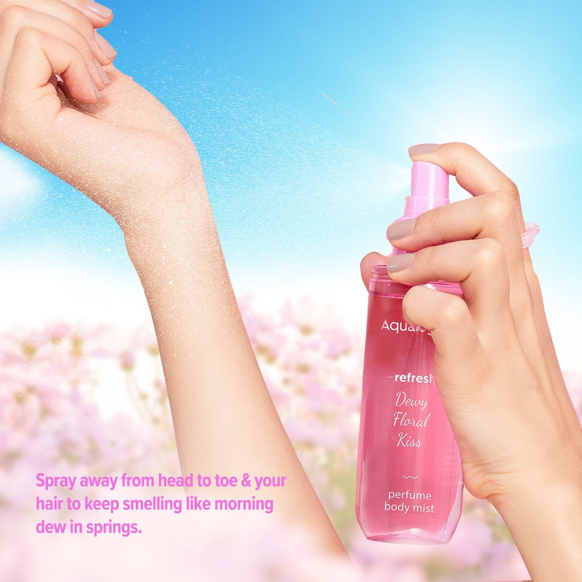 Hand spraying floral body mist with a dewy finish